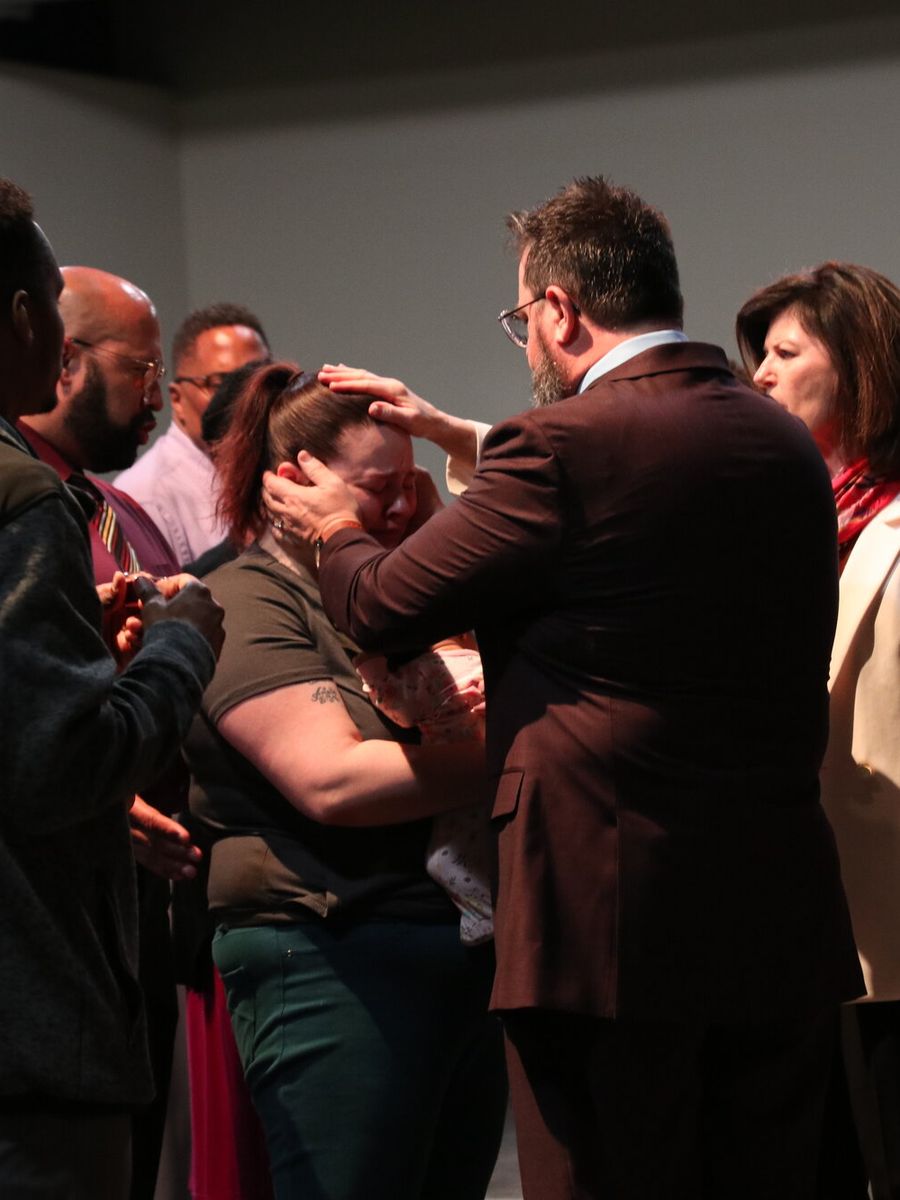 Pastor praying with a woman at the altar on Sunday